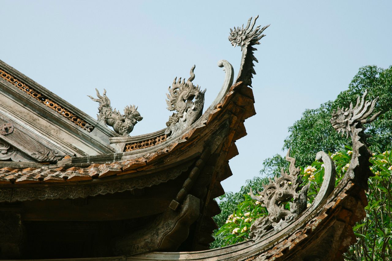 close up of a traditional asian temple roof with ornate dragon sculptu