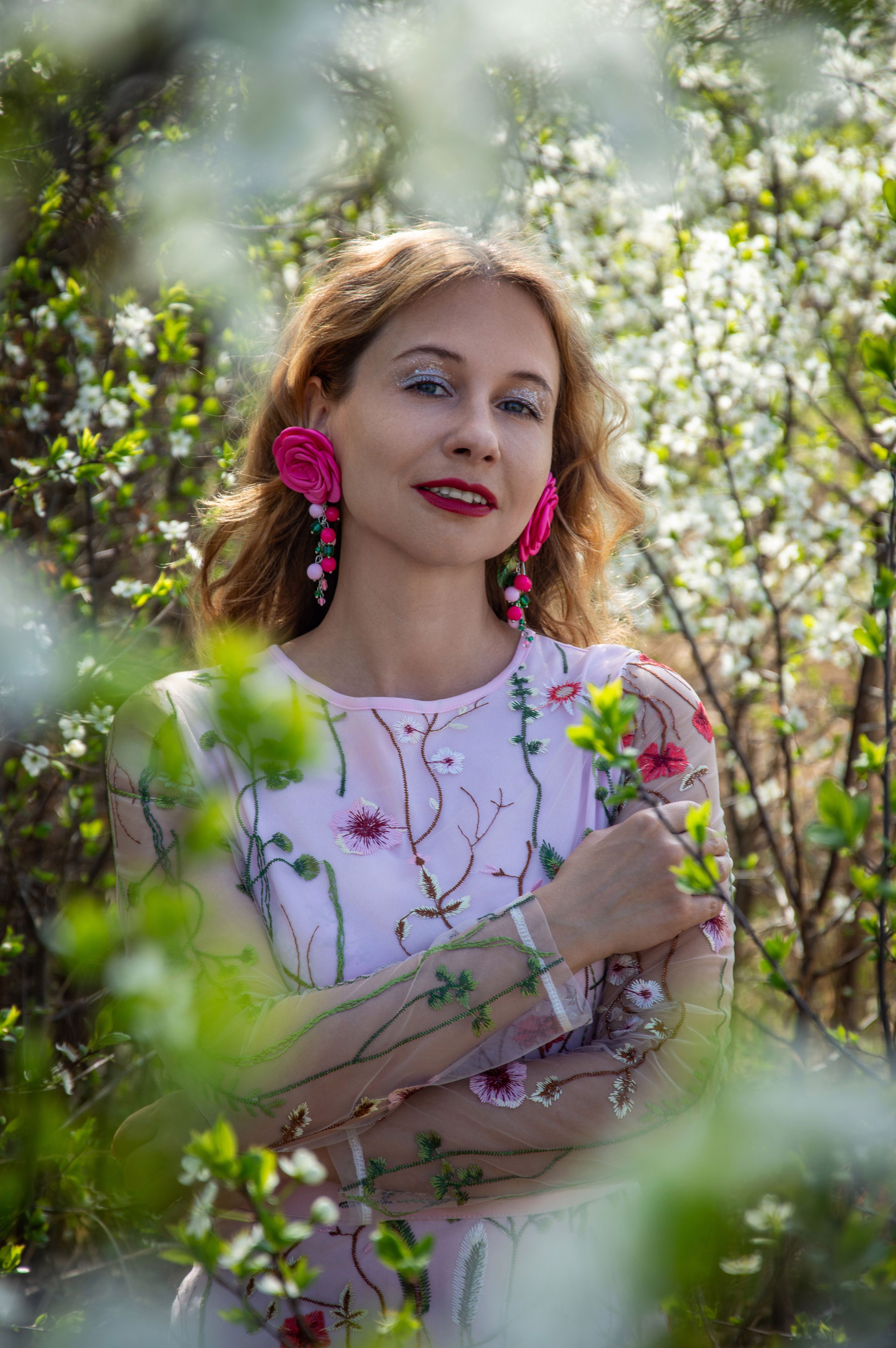 Woman in Floral Dress Posing Among Spring Blossoms · Free Stock Photo