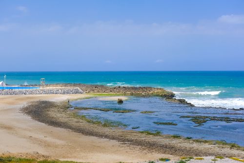 Free Breathtaking coastal scene capturing the vibrant blue sea and rocky shores of Rabat, Morocco. Stock Photo