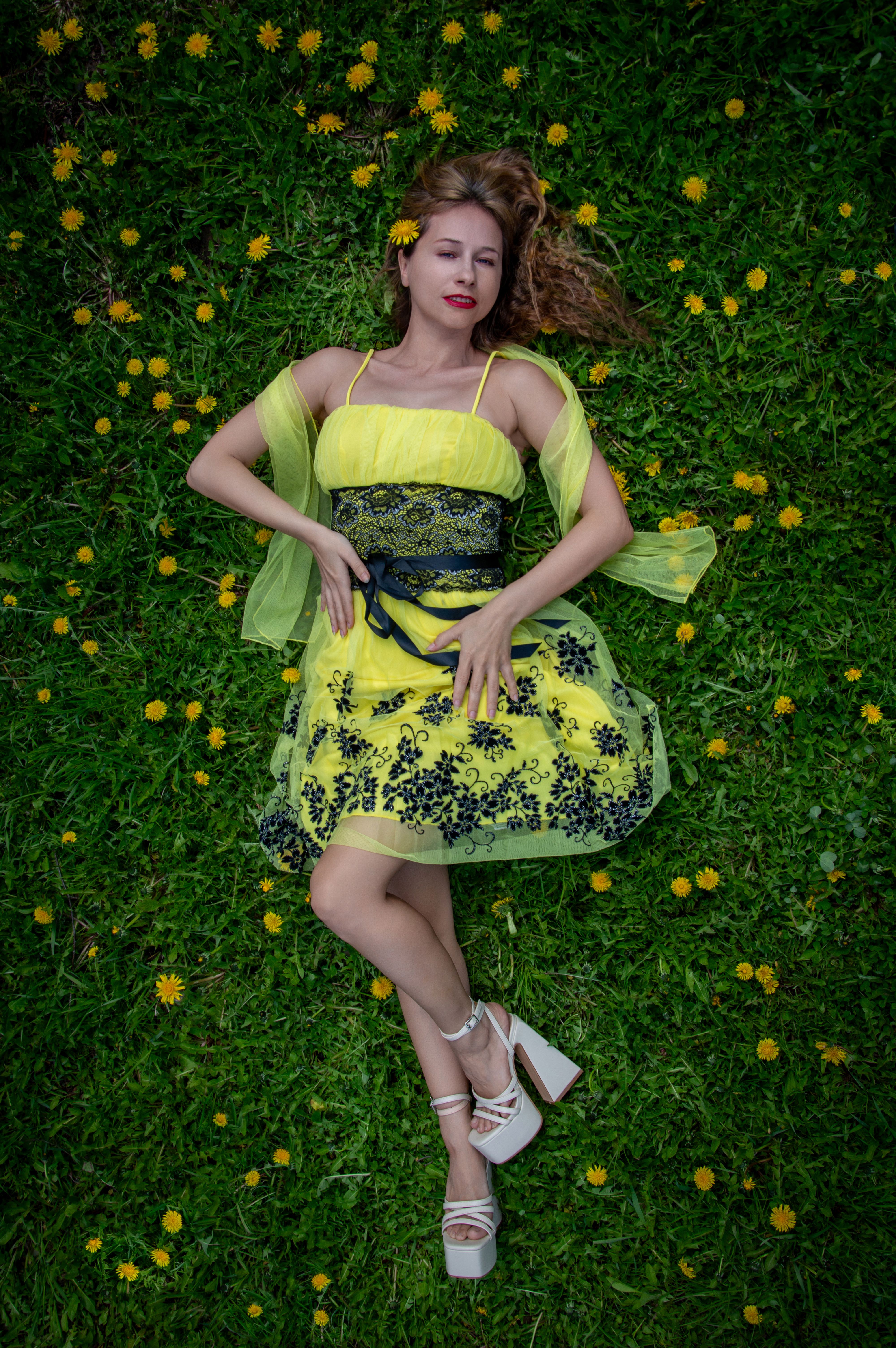 Woman in Yellow Dress Lying on Grass with Flowers · Free Stock Photo