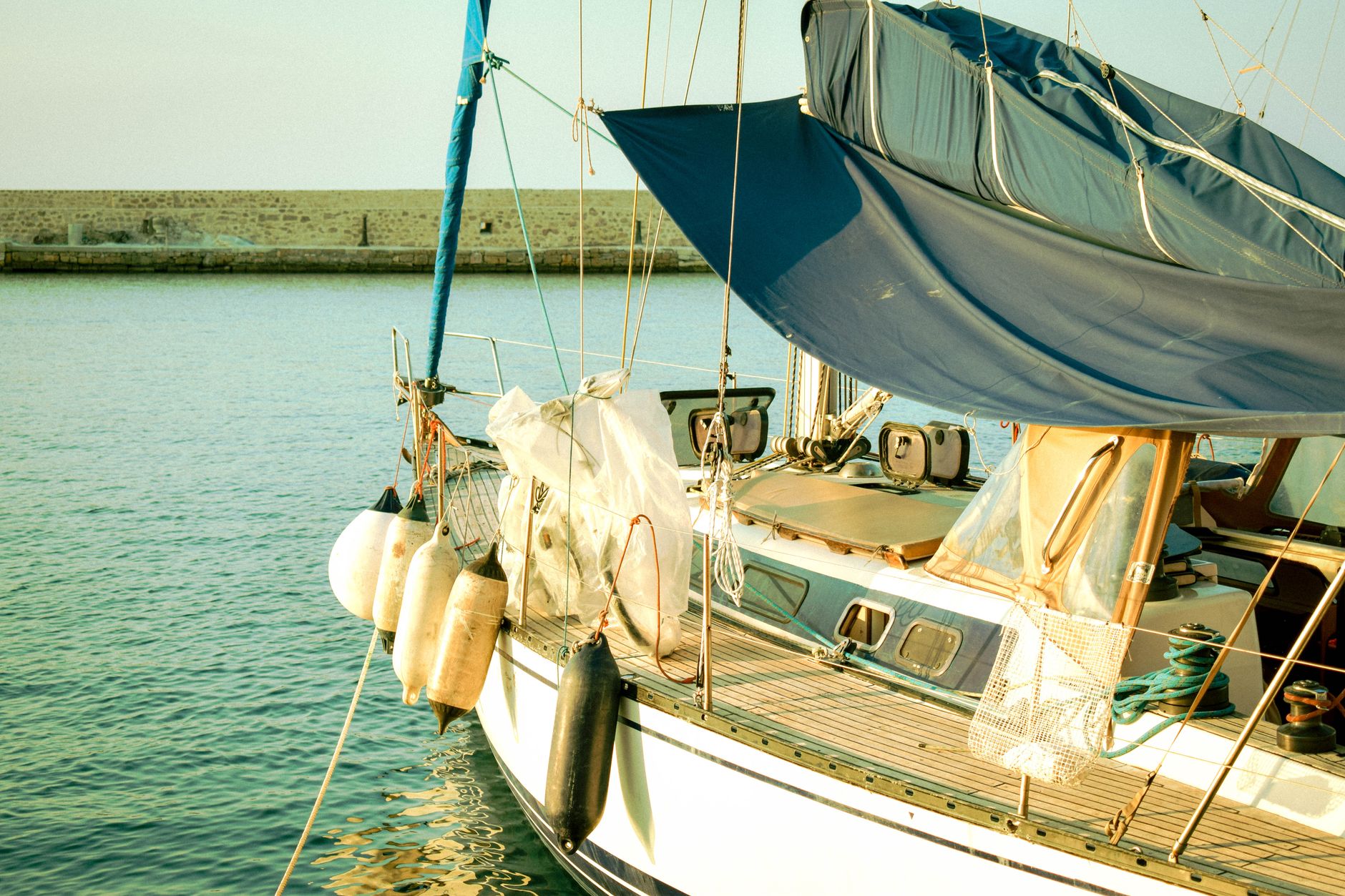 A minimalist view from a private yacht deck at sunset, emphasizing serene and elevated global travel.
