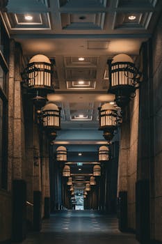 Moody indoor corridor featuring vintage lamps and architectural design in Melbourne, Australia.