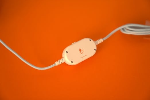 Headphone accessory on an orange background, showcasing sleek design.