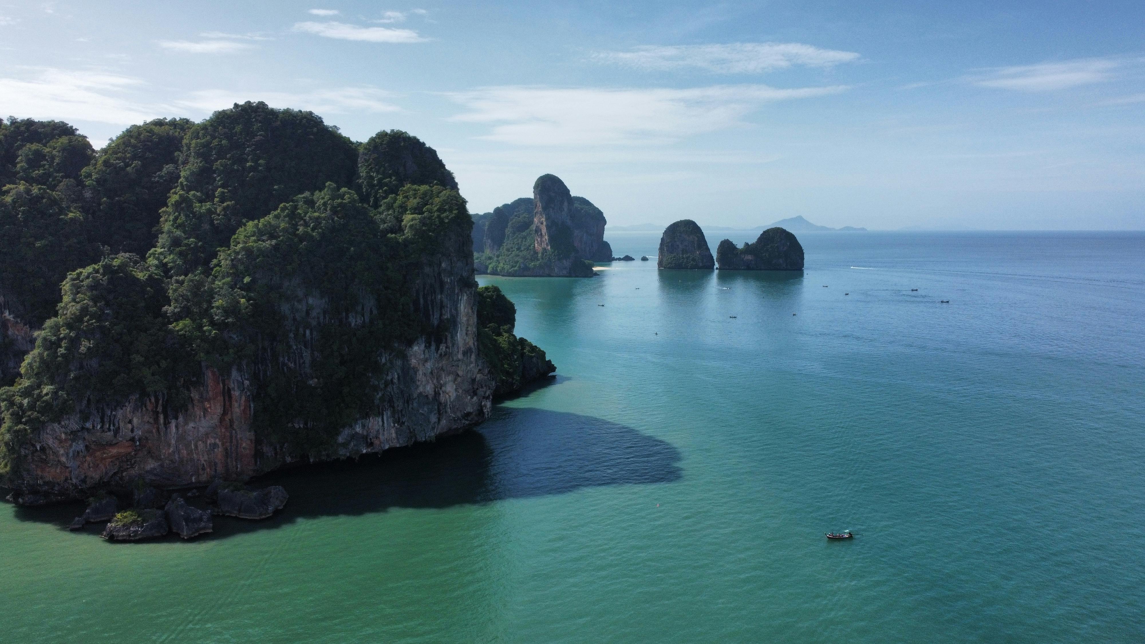 Breathtaking aerial shot of limestone islands in the clear waters of Thailand's coastline.