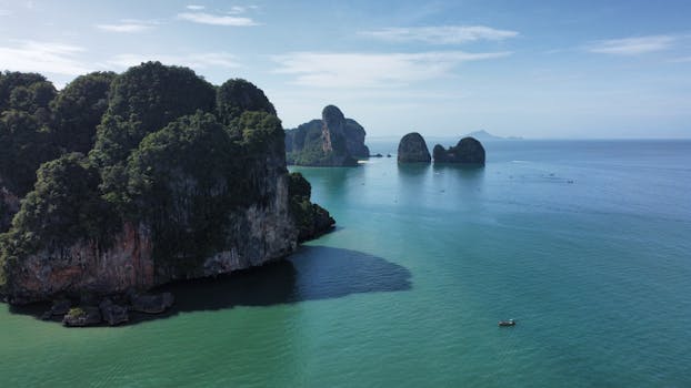Breathtaking aerial shot of limestone islands in the clear waters of Thailand's coastline.