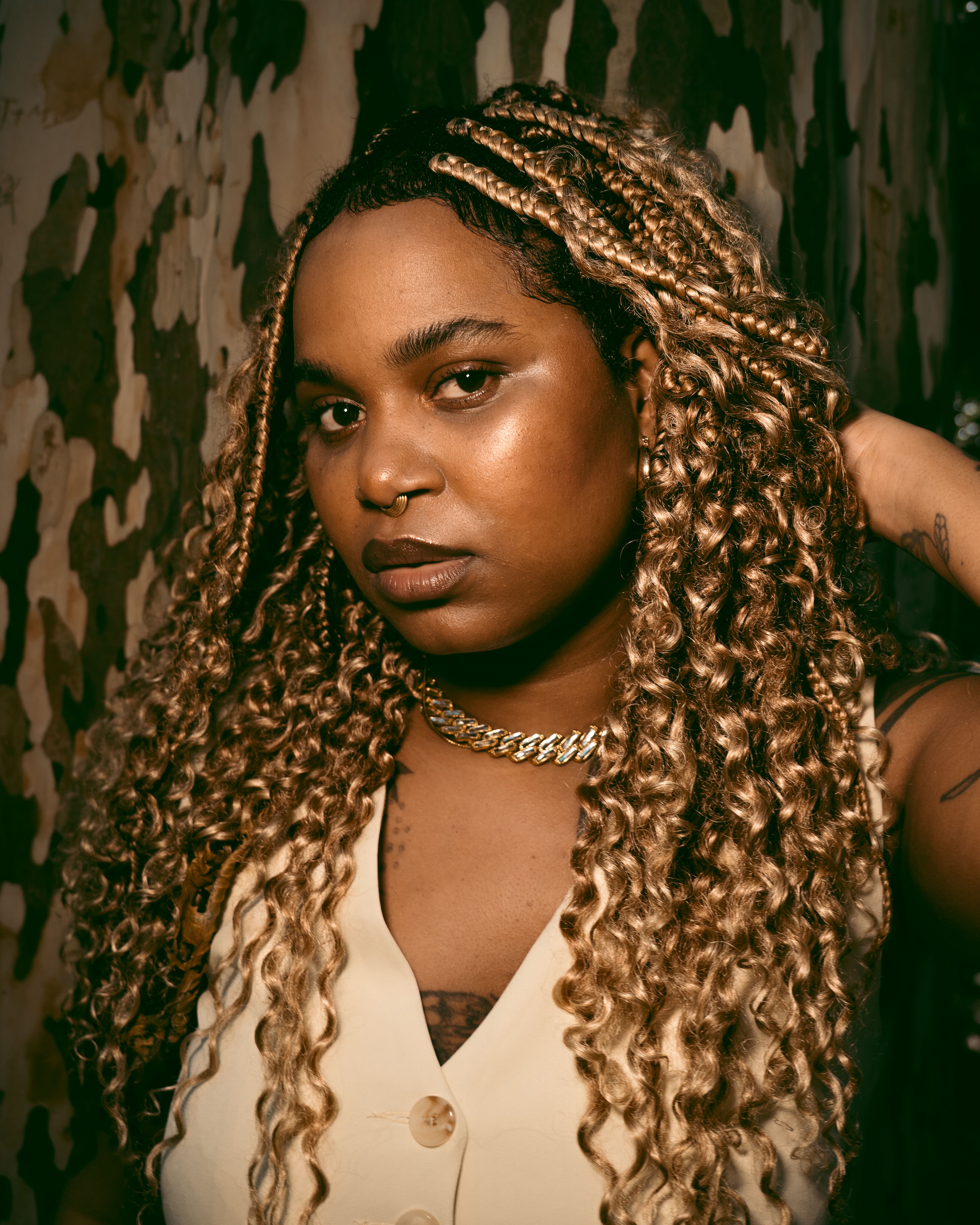 Powerful portrait of a woman with striking blonde braids, exuding confidence and style.