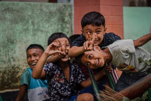 Free Lively group of children having fun, posing playfully outdoors. Stock Photo