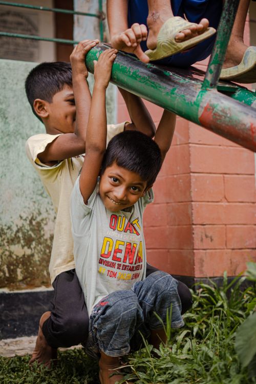 Free Happy children enjoying playtime on a colorful seesaw outdoors, expressing pure joy and friendship. Stock Photo