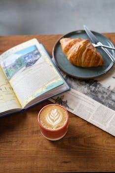 Enjoy a peaceful breakfast with a creamy latte, fresh croissant, and a good book.