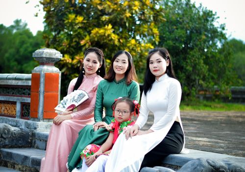 A beautiful family portrait outdoors with women in traditional attire.