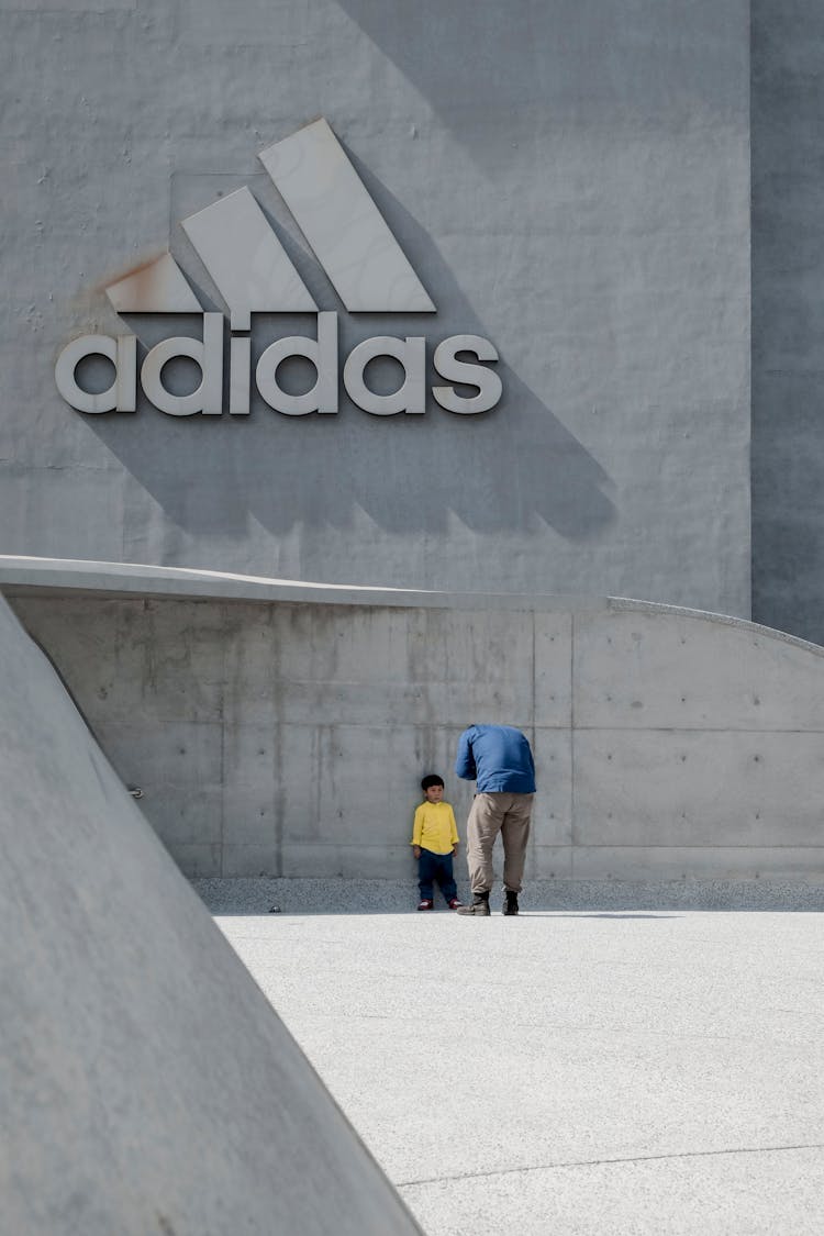 Man Taking Photo Of A Child Leaning On Wall