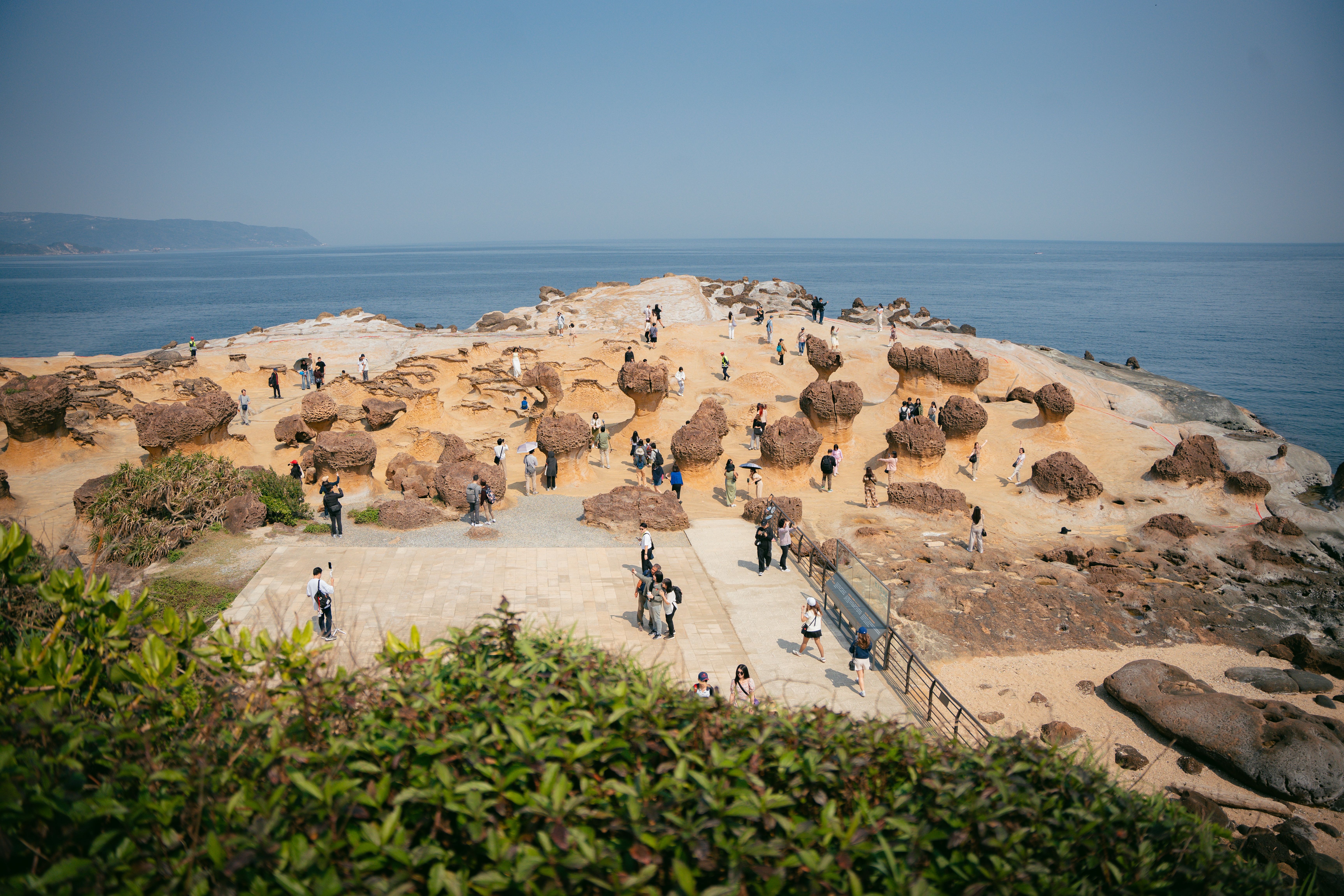 Visitors explore the unique rock formations at Yehliu Geopark, Taiwan's natural wonder by the sea.
