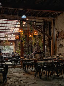 Charming rustic cafe interior with wooden decor and warm lighting, perfect for relaxation.