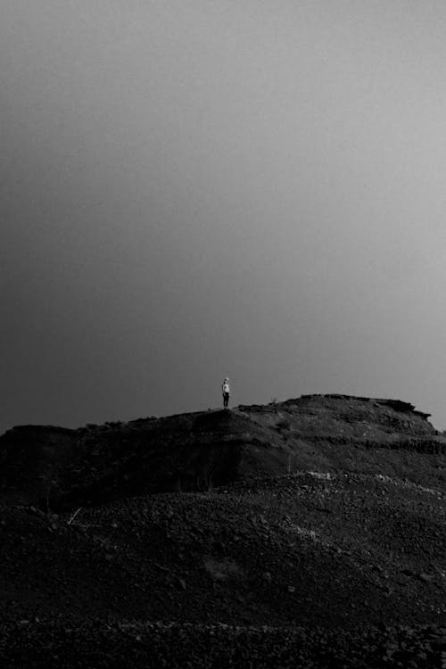 Monochrome Photo Of Person Standing On Desert