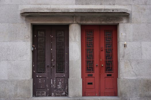 Art deco style red and brown doors in Porto, Portugal showcasing retro architectural design.