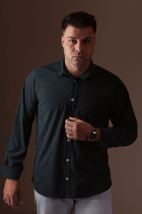 Free Portrait of a confident man in a dark shirt against a neutral background. Stock Photo