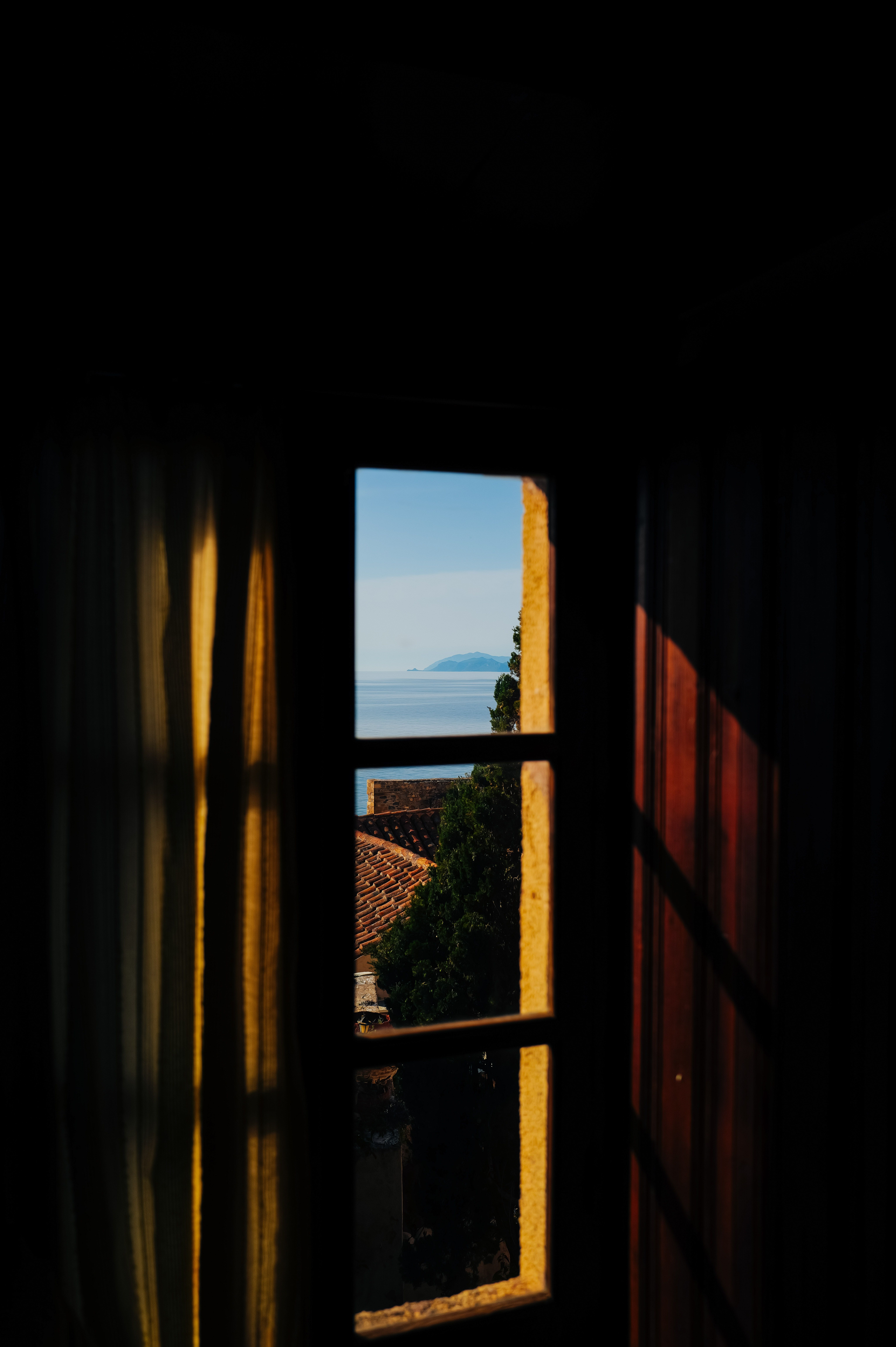 Serene Coastal View Through Window Frame · Free Stock Photo
