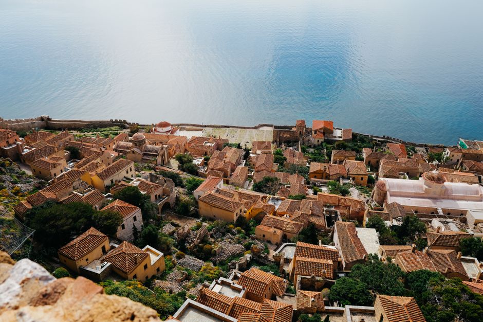 Discover the stunning aerial view of Monemvasia's historic architecture framed by the serene Mediterranean Sea.