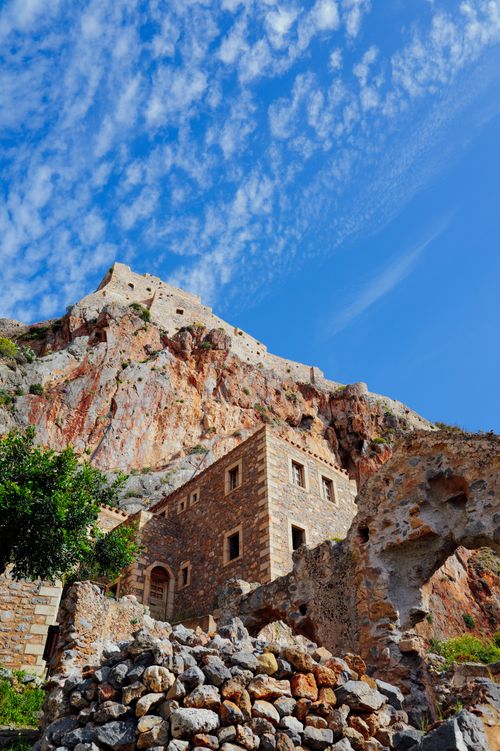 Free Ancient stone fortress ruins with blue sky and clouds. Perfect for historical and travel themes. Stock Photo