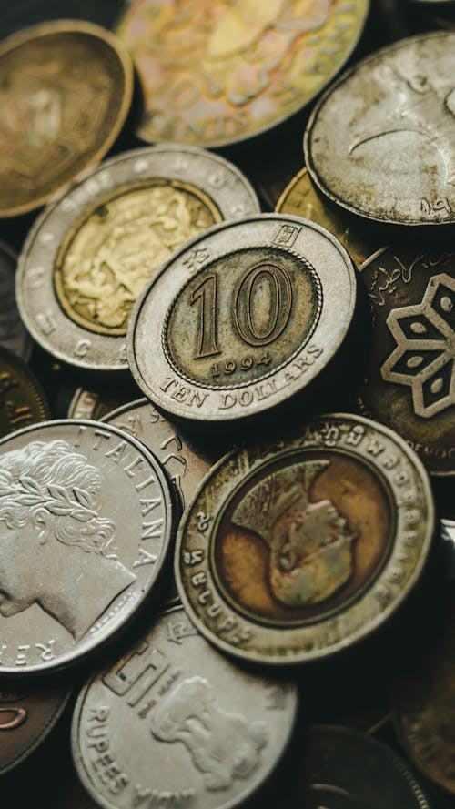 Free Closeup of old golden and silver coins placed in heap next to each other Stock Photo