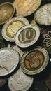 Closeup of old golden and silver coins placed in heap next to each other