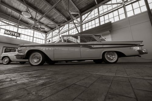 Free Black and white image of vintage 1950s cars in an indoor showroom, nostalgic atmosphere. Stock Photo