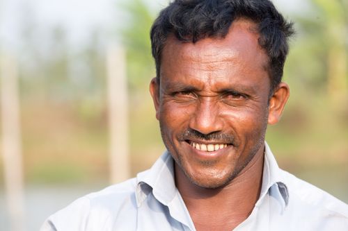 Free Portrait of a smiling man outdoors, capturing a joyful moment in Bangladesh. Stock Photo