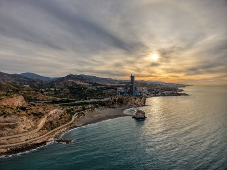 A scenic aerial view of Málaga's coastline during a stunning sunset in Andalusia, Spain.