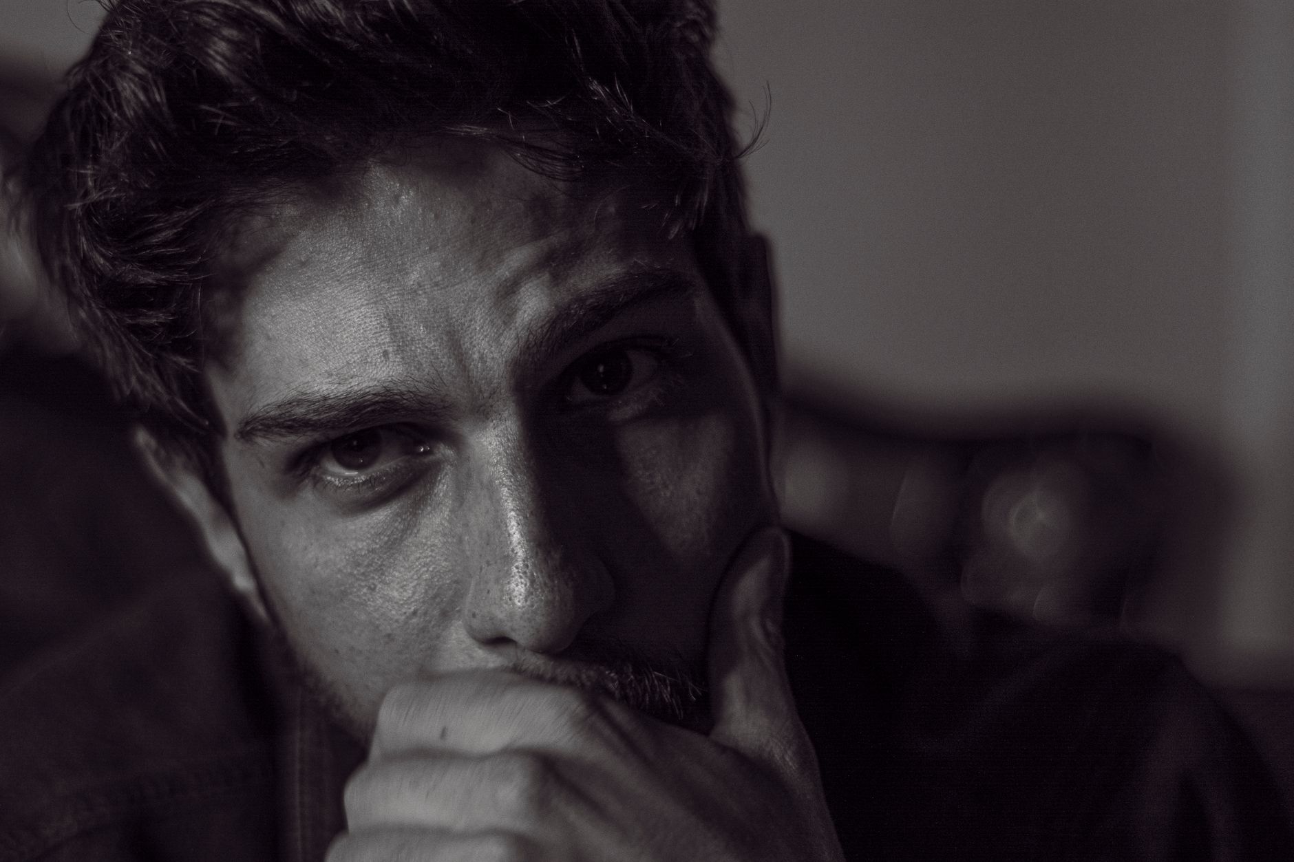 Expressive black and white portrait capturing deep thought and emotion.