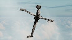 Futuristic Spacecraft Hovering Above Clouds