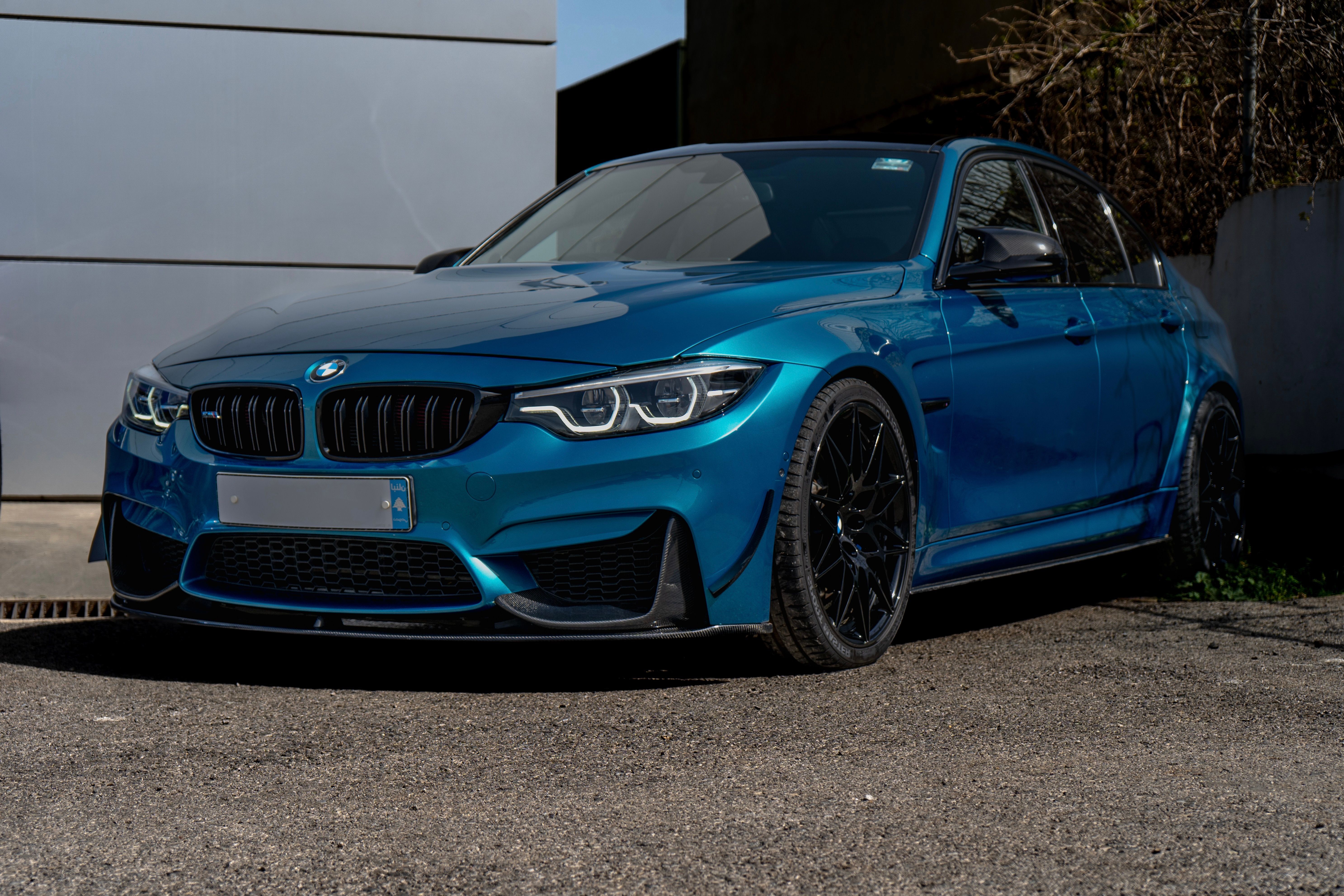 Sleek Blue Sedan Parked on Urban Street · Free Stock Photo