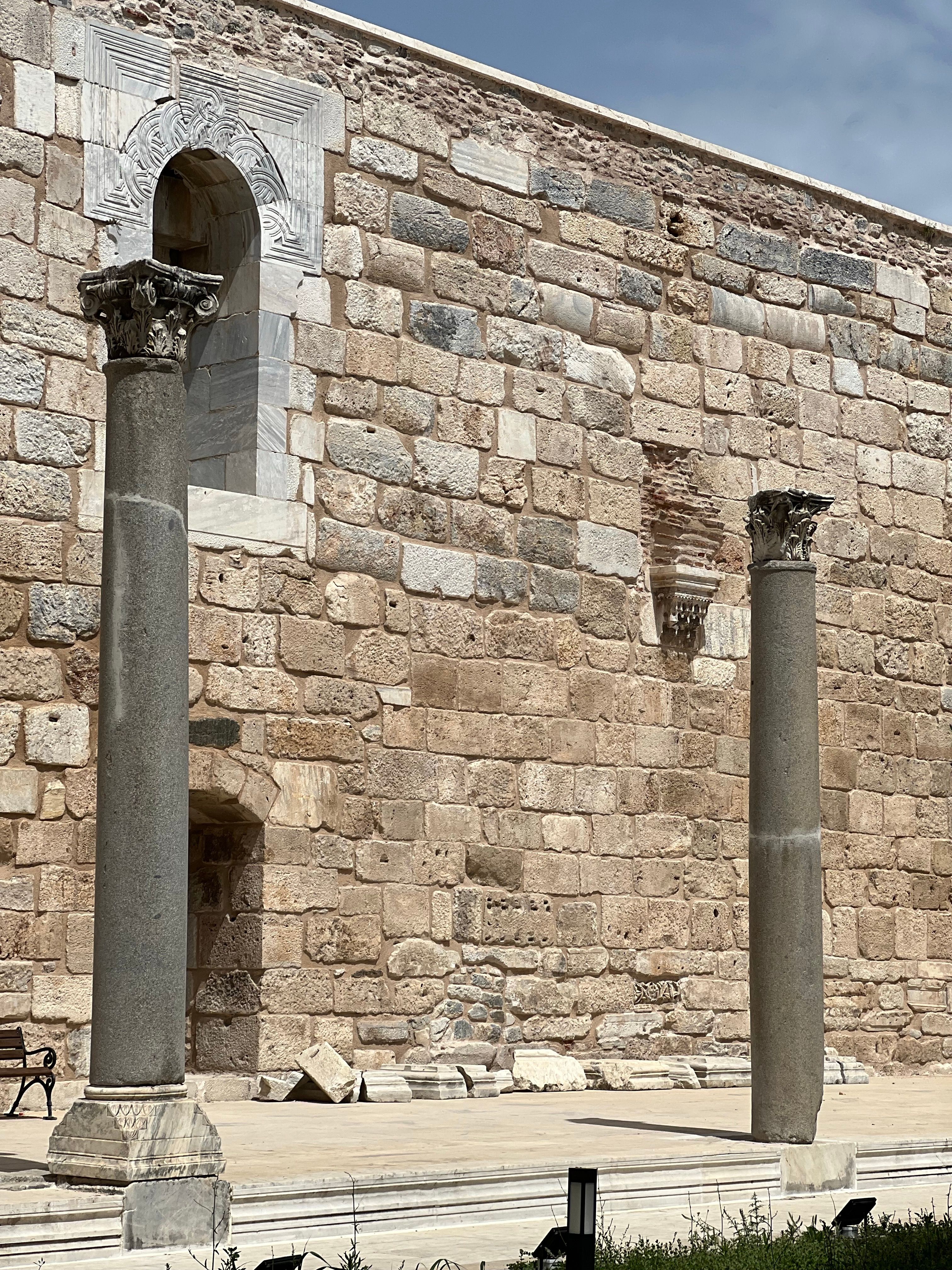 Ancient Roman Columns in Izmir against Stone Wall · Free Stock Photo