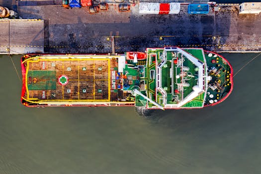 Photo by Tom Fisk Top-down view of a colorful cargo ship docked in Jakarta, showcasing logistics and transportation.