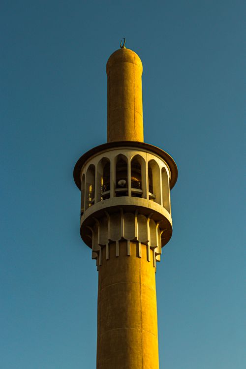 Free A beautifully captured minaret in Dubai against a clear blue sky, showcasing Islamic architecture. Stock Photo