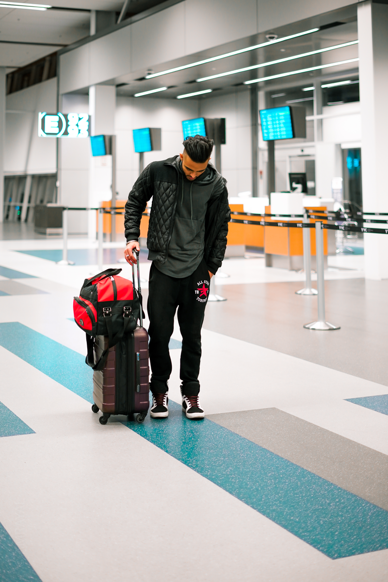 Traveller with luggage in a modern airport terminal