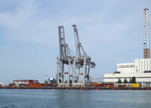 Industrial scene of cranes and containers at Le Havre port, France.