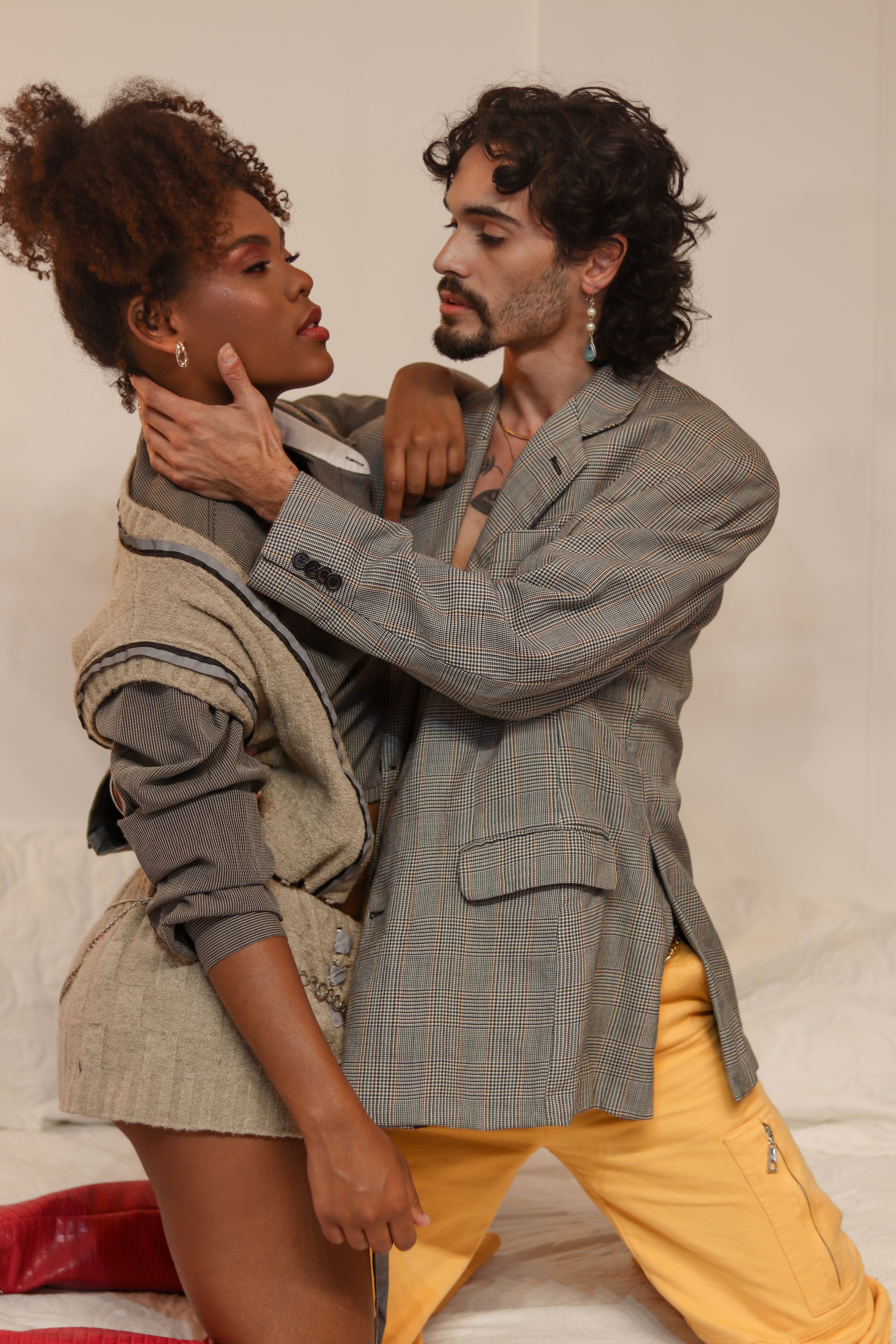 Stylish couple posing intimately, showcasing modern fashion and emotional connection.
