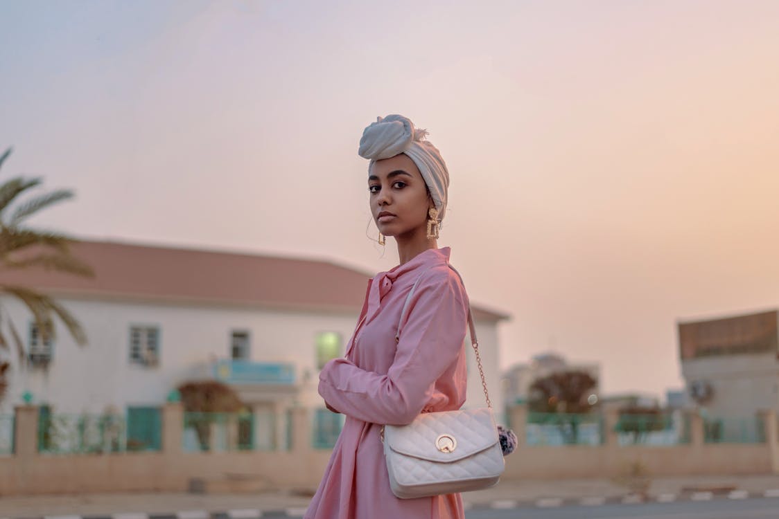 Selective-focus Photograph of Woman in Pink Dress With Leather Bag