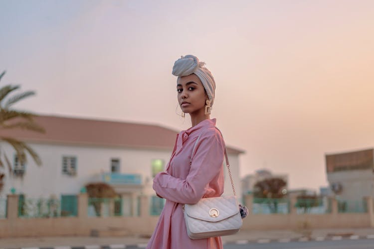 Selective-focus Photograph Of Woman In Pink Dress With Leather Bag