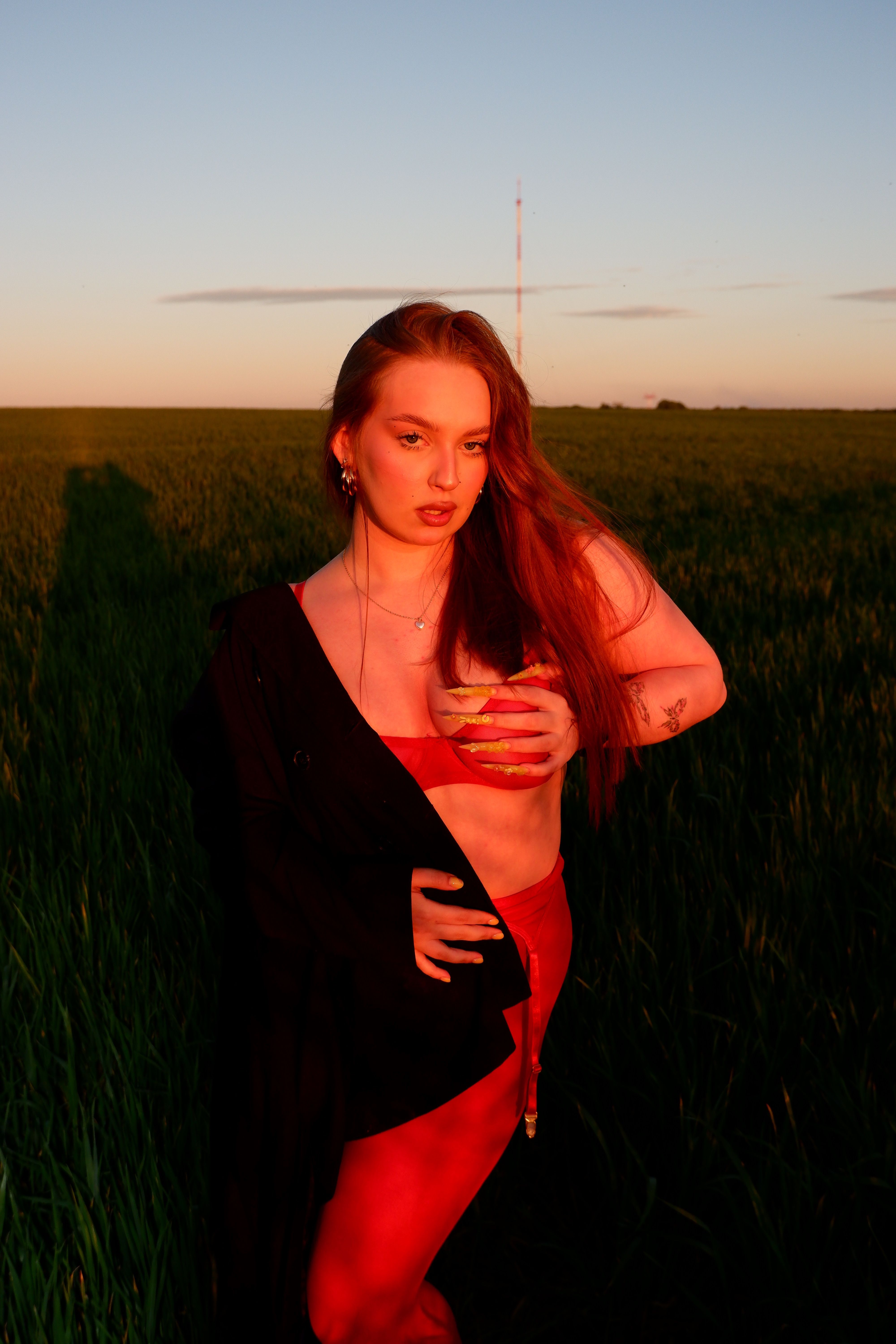 Young Woman in Red at Sunset in Open Field · Free Stock Photo
