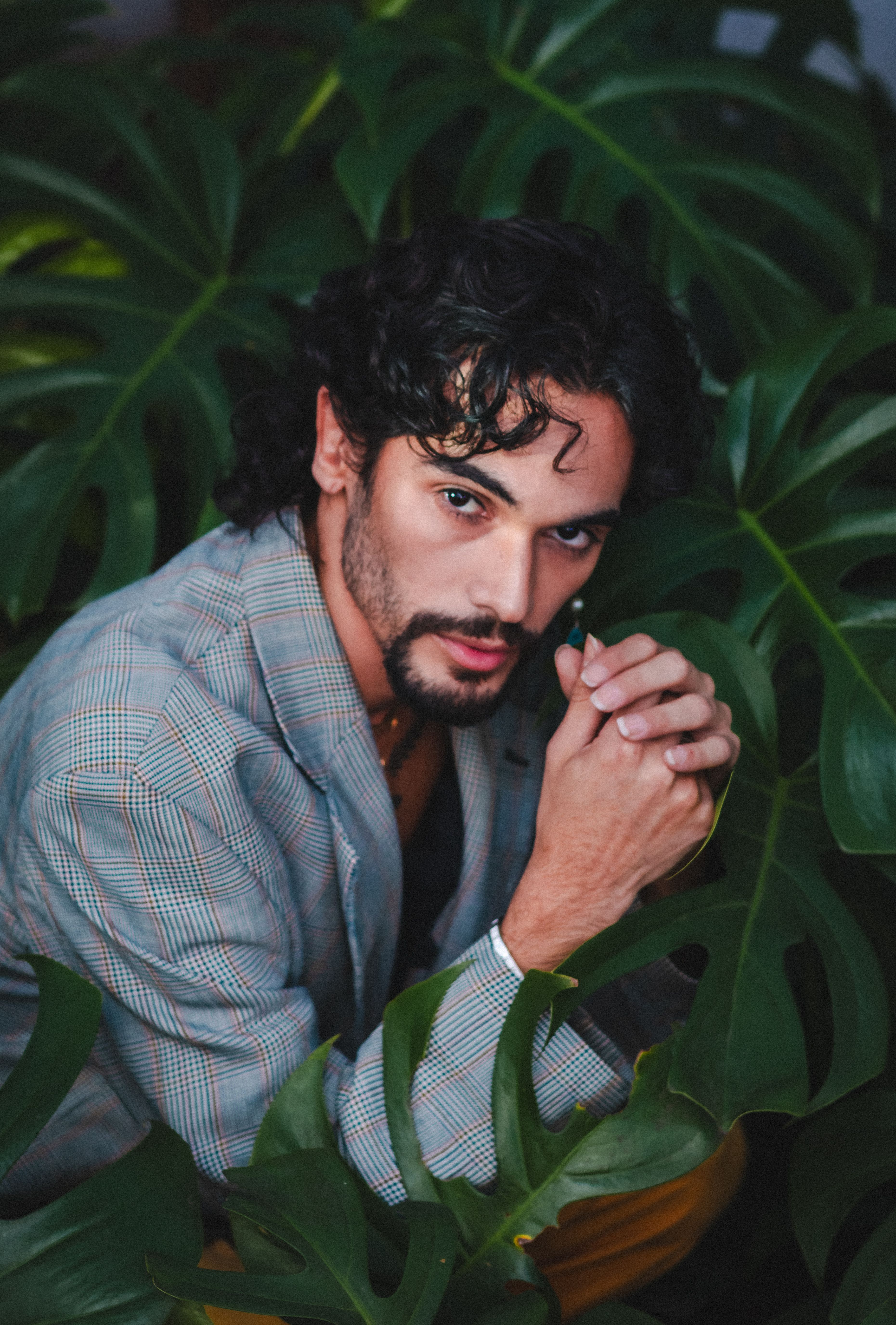 Portrait of Man Among Lush Green Leaves