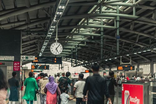 Free Commuters navigate the bustling platforms of a Dhaka train station, capturing daily urban transit life. Stock Photo
