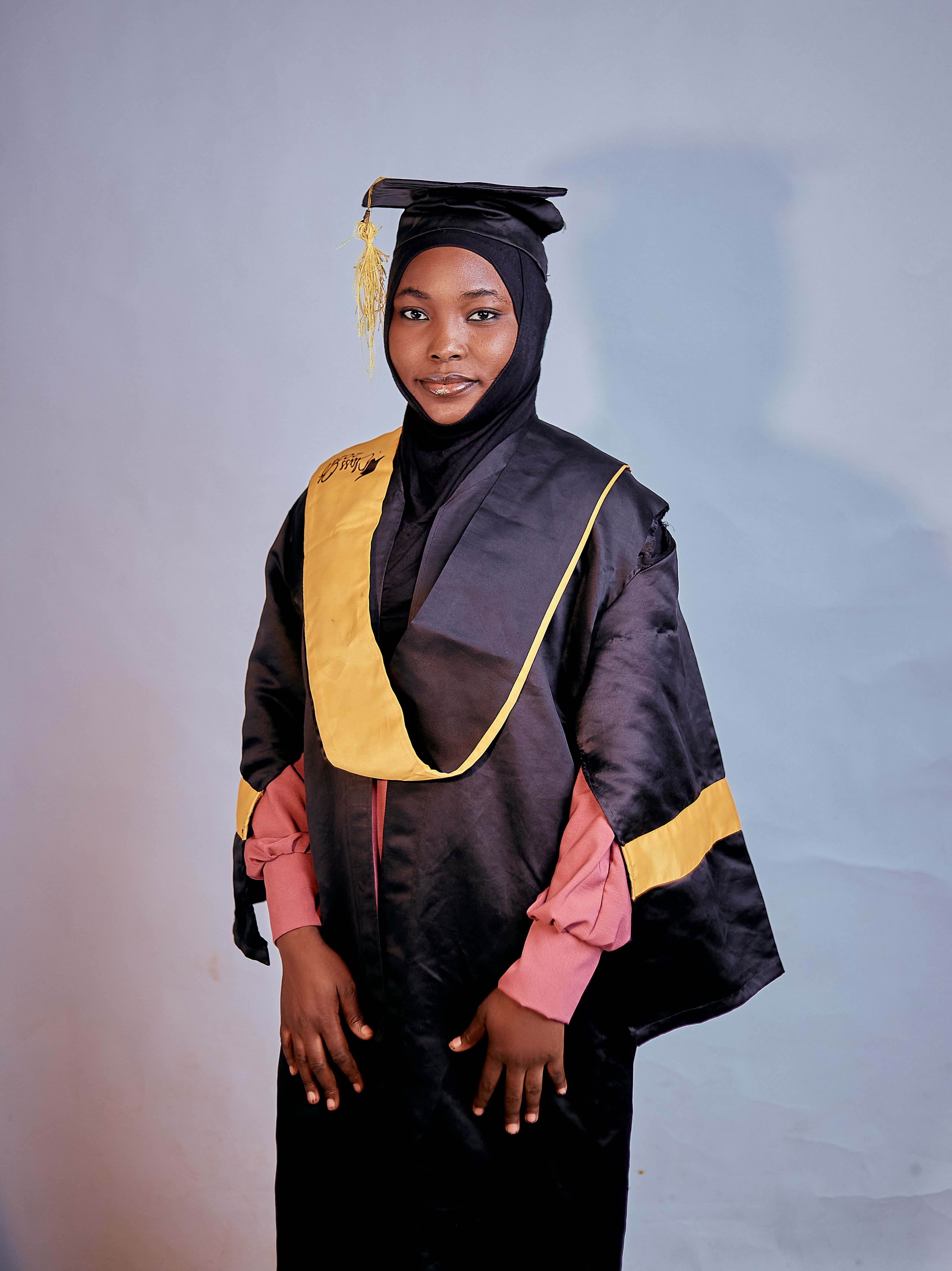Proud Graduate in Cap and Gown Studio Portrait · Free Stock Photo
