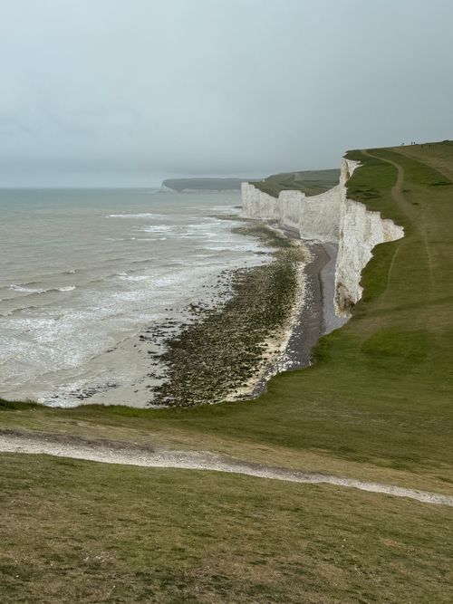 Free Majestic view of the famed white cliffs with a moody sky above the sea. Stock Photo