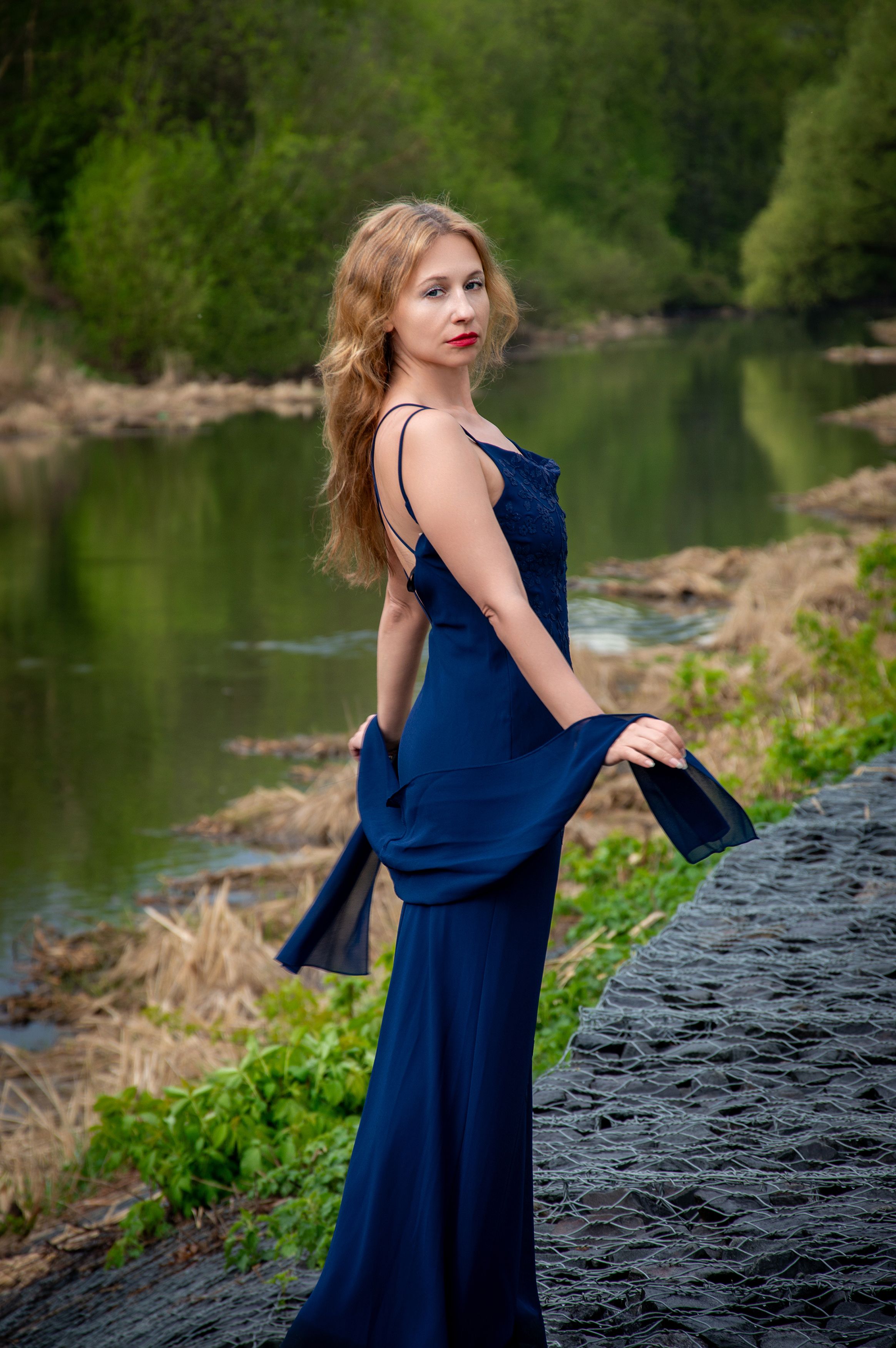 Elegant Woman in Blue Dress by Riverside in Nature · Free Stock Photo