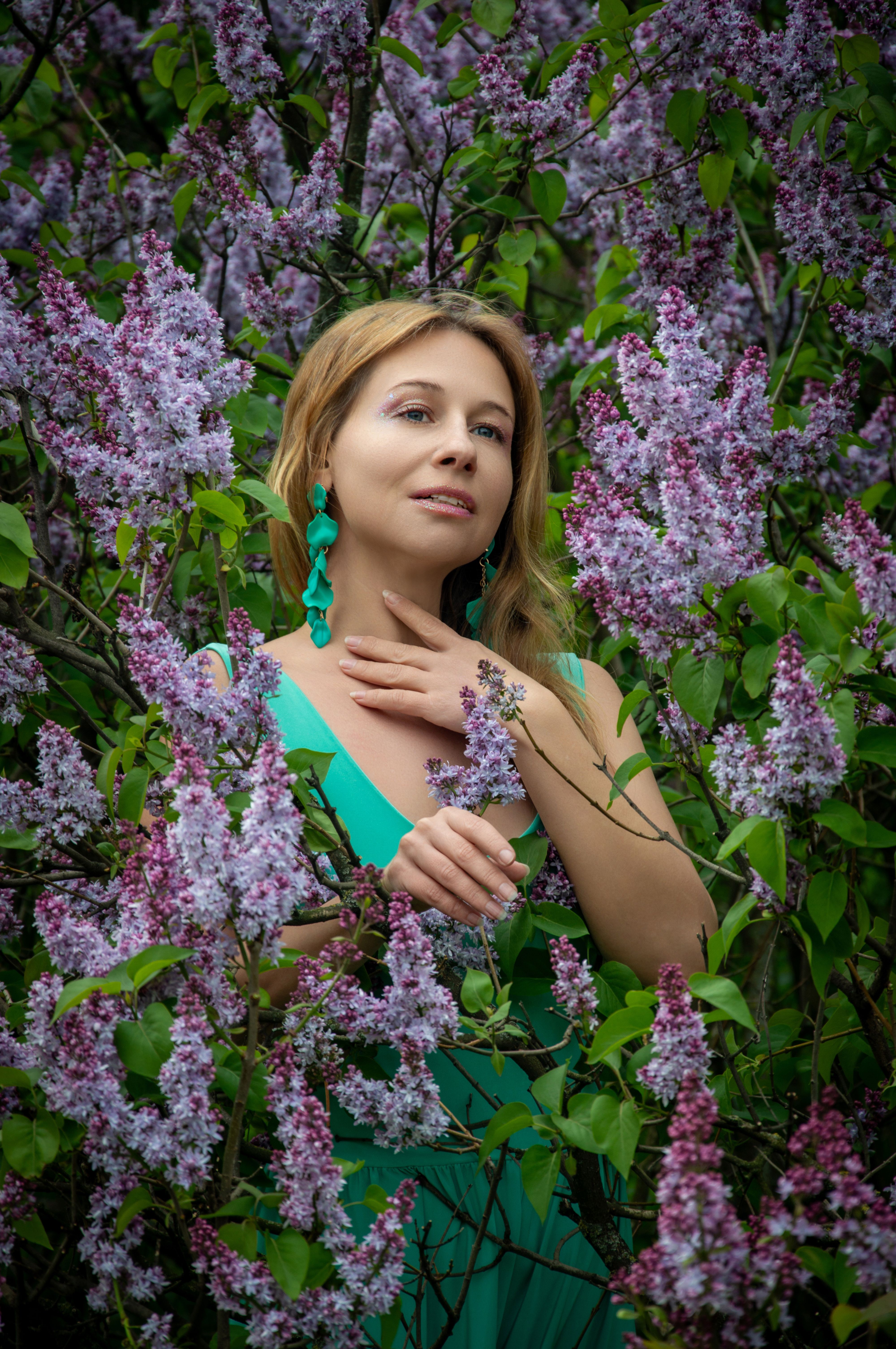 Woman in Green Dress Among Blooming Lilac Bushes · Free Stock Photo