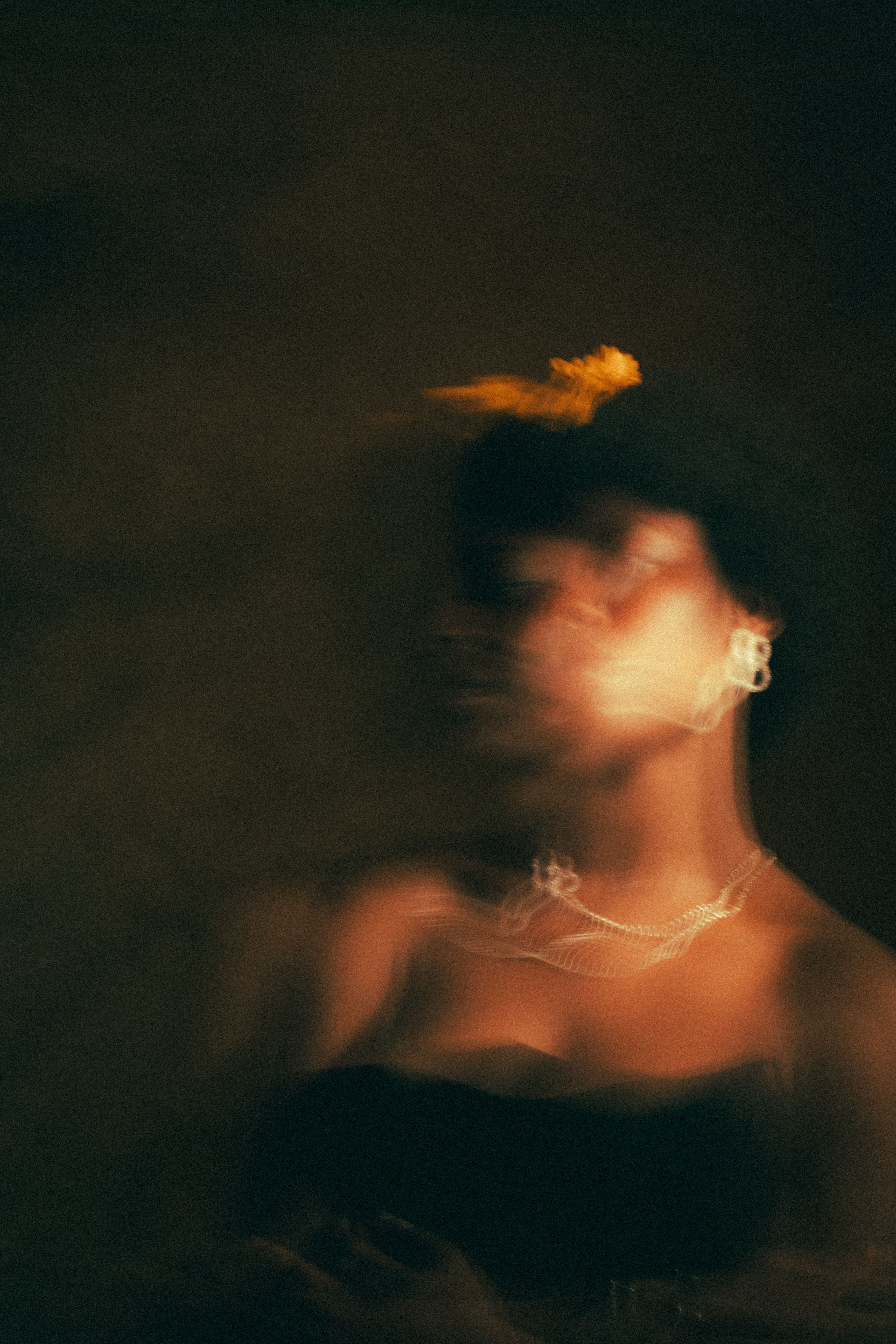 Artistic Blurred Portrait of Woman with Yellow Flower · Free Stock Photo
