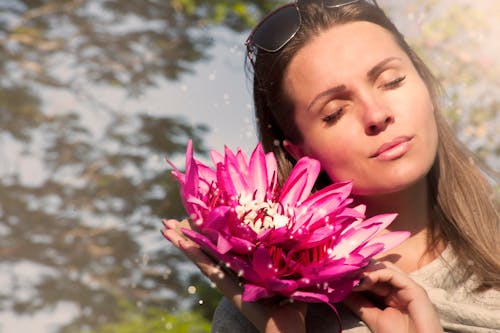 Free Woman Holding Pink Water Lily Flowers Stock Photo