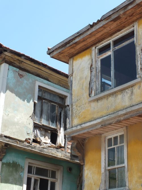 Free Old, abandoned houses with weathered facades under clear blue sky. Ideal for exploring urban decay themes. Stock Photo