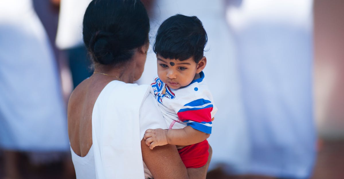 Selective Focus Photography of Woman Holding Child